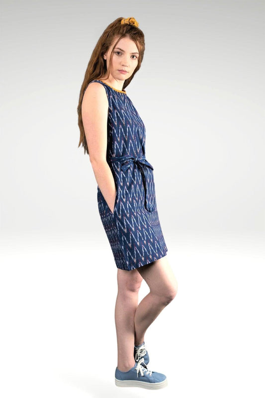 MODEL WEARING FIDA IKAT DRESS SHOWING SIDE VIEW WITH HANDS IN POCKETS- zohaonline