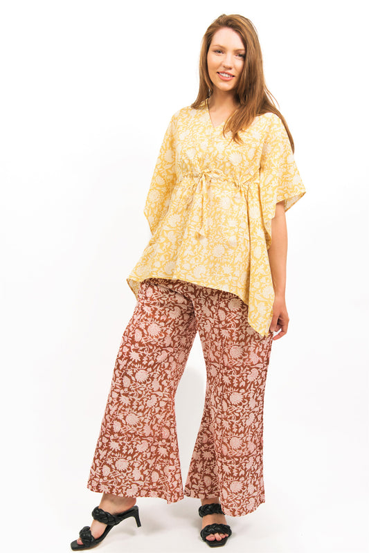 MODEL WEARING ZINNIA SHORT COTTON KAFTAN TOP IN LIGHT YELLOW WITH WIDE LEG PANTS- zohaonline