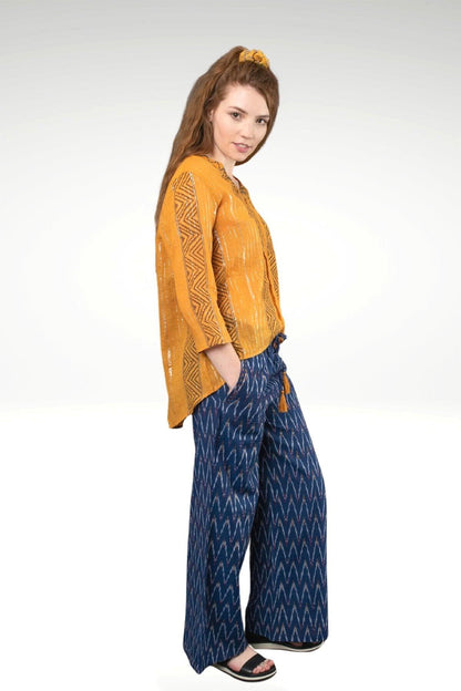 KIA IKAT PANTS - zohaonline- side view on the model- blue ikat with yellow, red , white ikat design