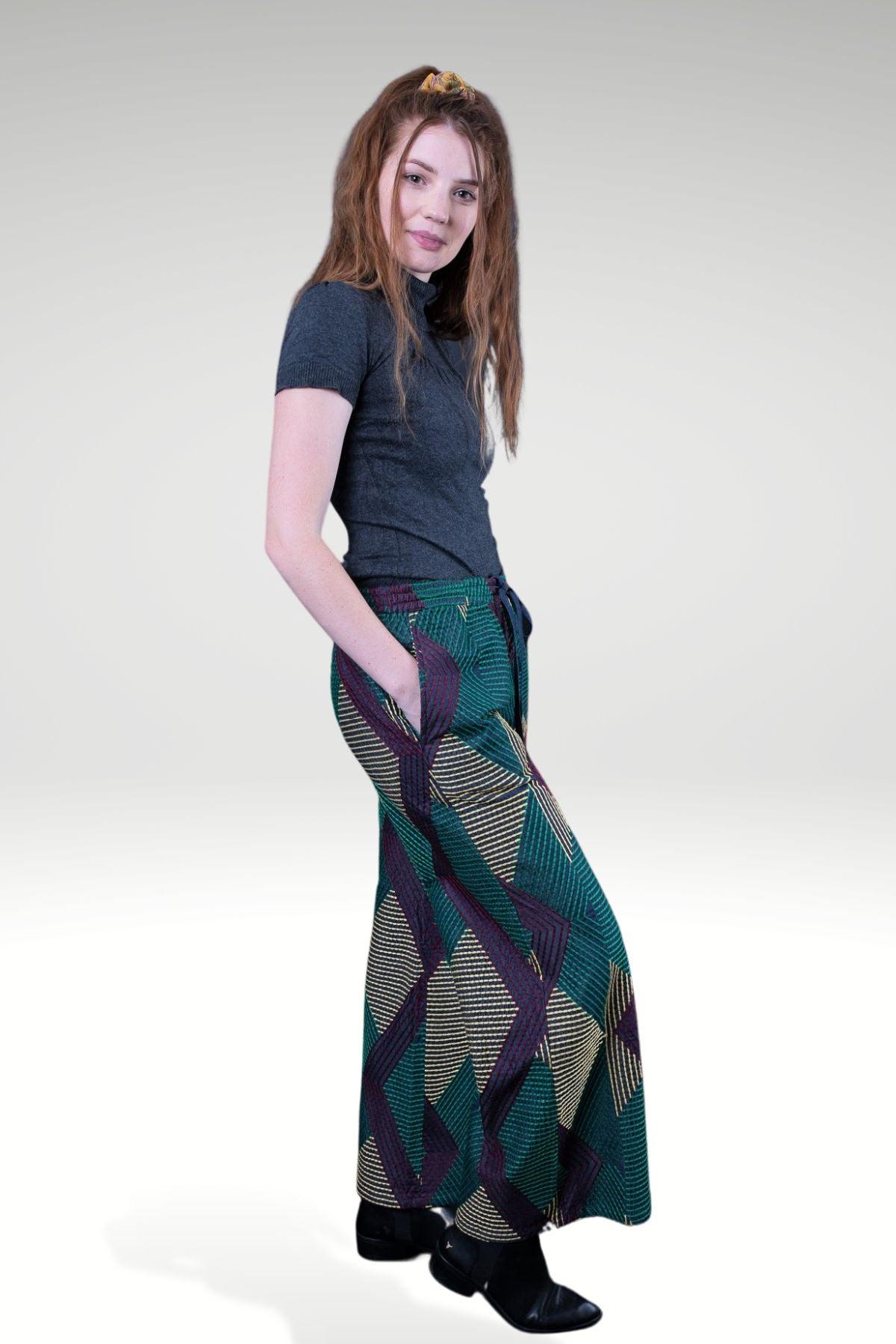 DONNATELLA EMBROIDERED WIDE-LEG PANTS - zohaonline- side view on the model paired with high neck knit top