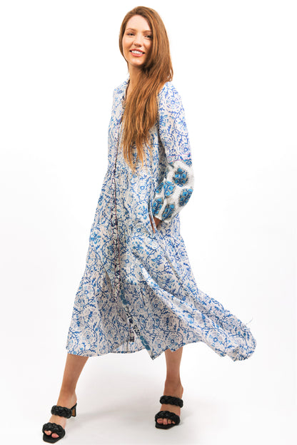 MODEL SWIRLING IN IRIS PRINTED TIER MIDI DRESS WITH HANDS IN POCKETS - zohaonline
