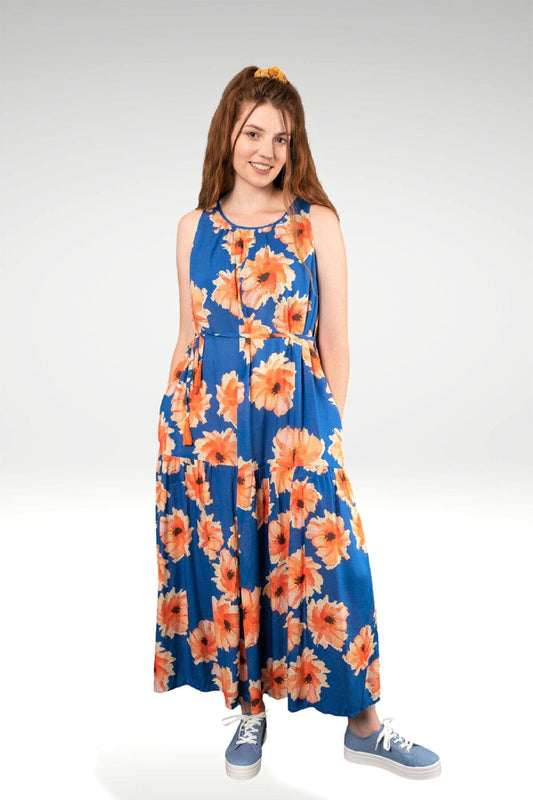 a modal maxi dress in bright blue with bright flower print and a waist tie belt with tassels- front view on a model