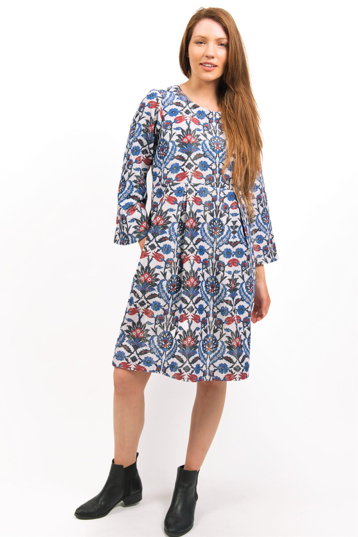 MODEL WEARING LUNA LUREX PRINTED FLORAL DRESS WITH ONE HAND IN POCKET- zohaonline