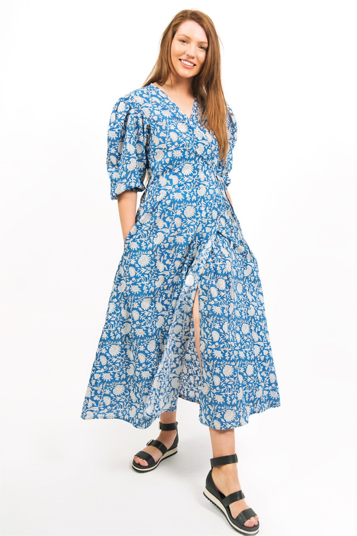 COBALT COLOR ZEPHYR PRINTED WRAP MAXI DRESS -FRONT VIEW ON MODEL WITH HANDS IN POCKETS- zohaonline