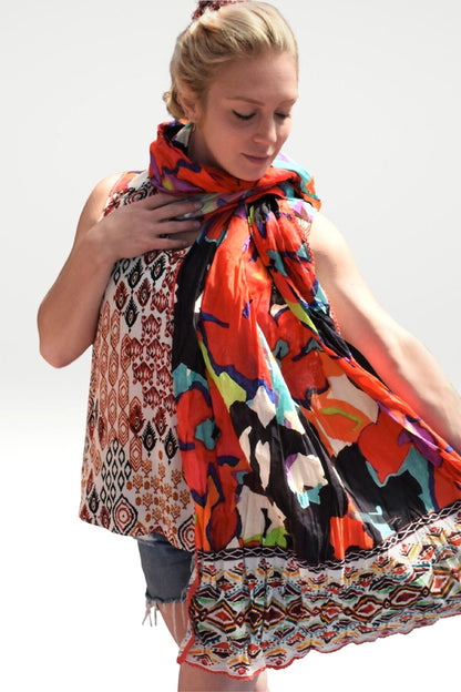 FLOWER PRINT WRAP WORN AROUND THE NECK BY THE MODEL 